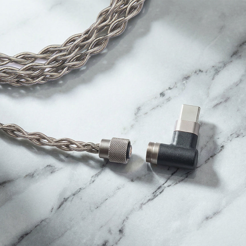 Braided audio cable with a connector on a marble surface