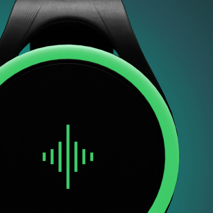 Close-up of a black round wrist device with a glowing green outer ring