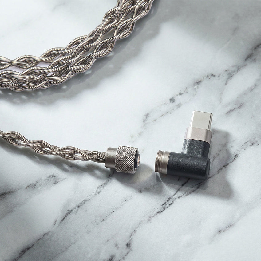 Braided audio cable with a connector on a marble surface