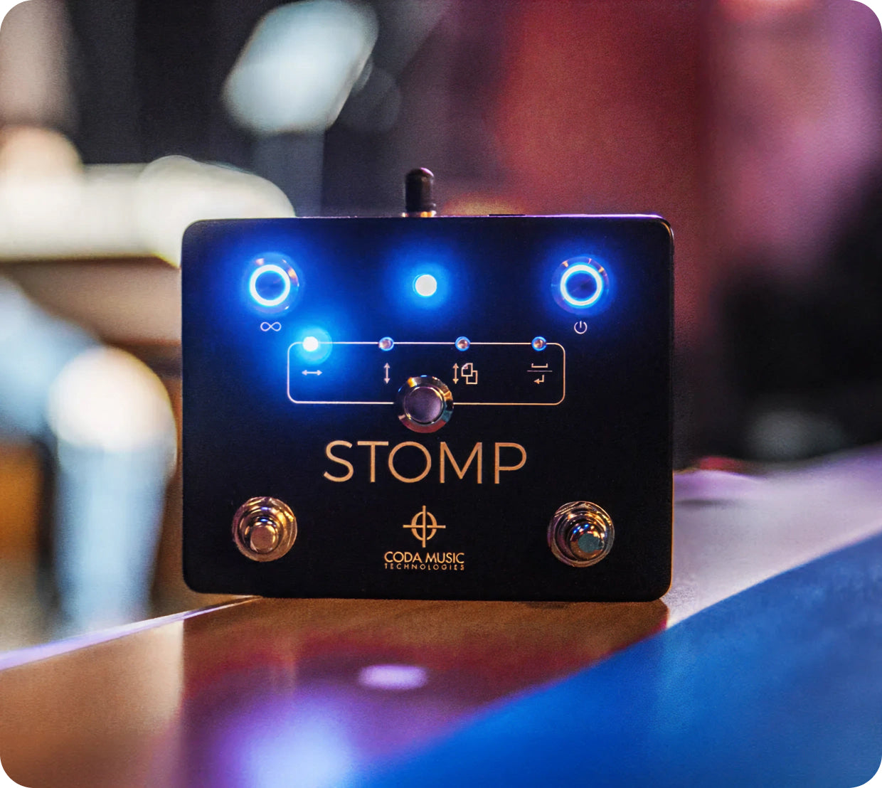 Black stomp box with blue lights on a blurred background