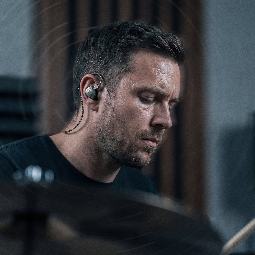 Man wearing a wired in-ear monitor