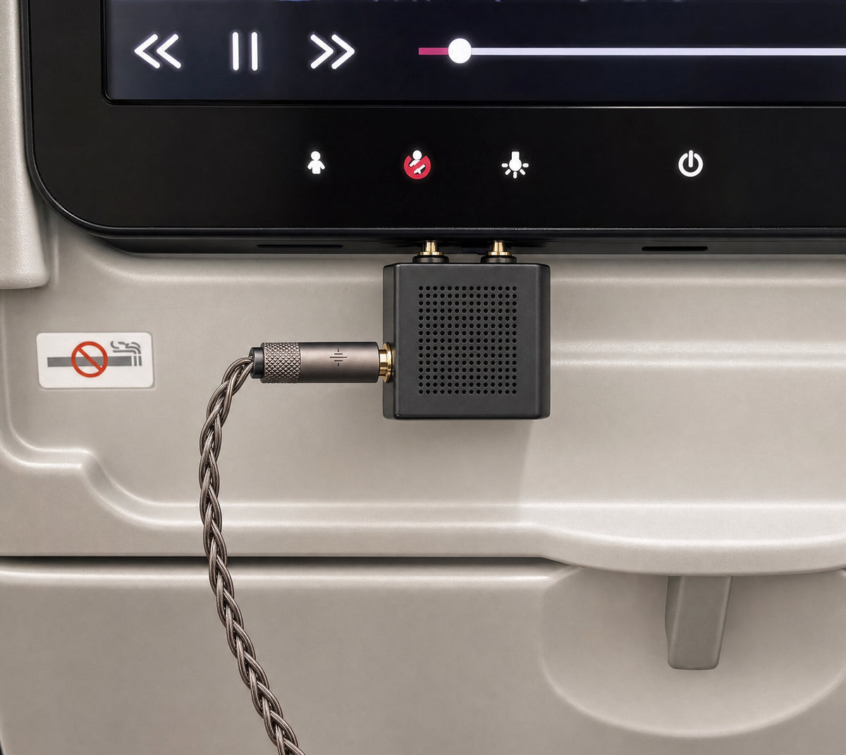 Wave Pro 2 cable connected to a two-prong airplane audio adapter at a seatback screen